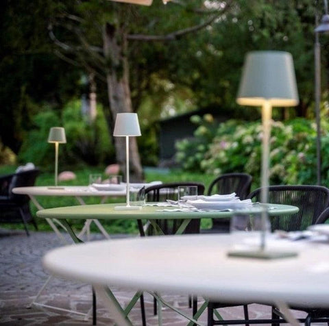 A white Zafferano poldina pro used to create ambience on a restaurant table as decorative lighting
