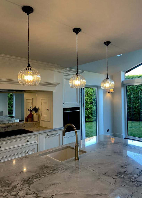 modern brass ceiling light with multiple exposed bulbs in stylish interior