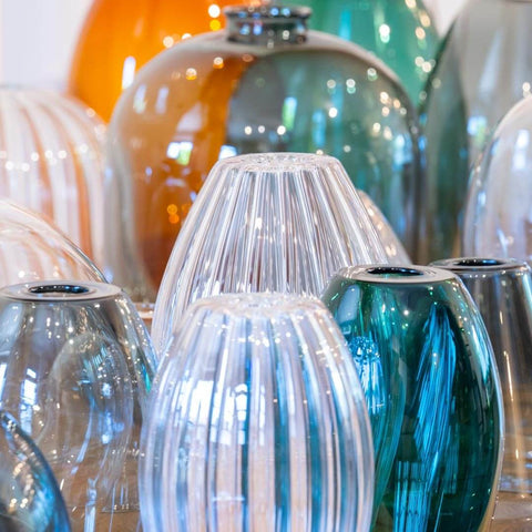 Hand cleaning a glass pendant light with a soft cloth for maintenance and care