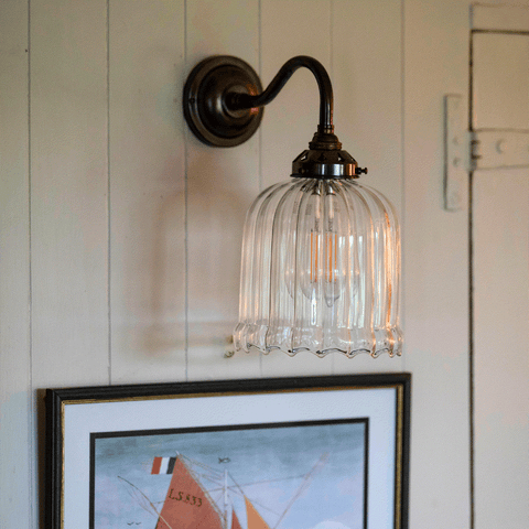 modern wall lighting ideas in living room with brass sconces and layered lighting design
