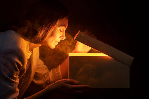 Woman opening a box to view her new wall light.