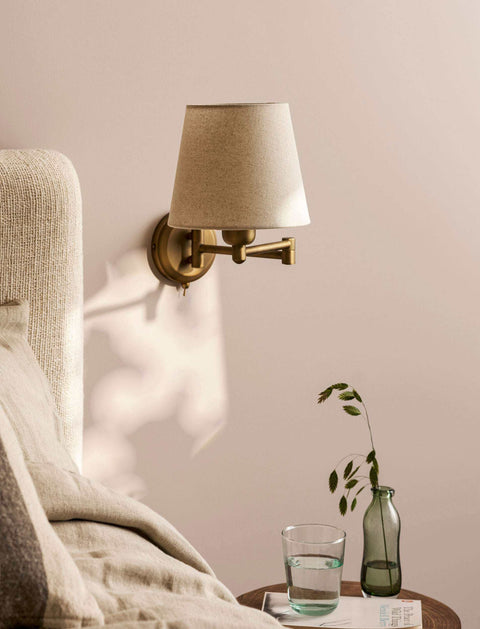 Bedside Wall Lights with a brass wall mount and beige fabric shade, featuring a compact reading-light design