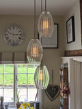 Camber Large Ribbed Glass cluster pendant light with three oval ribbed glass shades hanging in modern interior