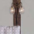 Camber Small Ribbed Glass Shade wall light with two fluted oval glass shades mounted on a rustic wooden beam above a patterned cushion