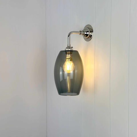 Camber Small Smoked Glass Shade wall light with elongated smoked glass shade and chrome fixture mounted on white wall