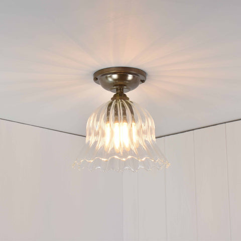 Bodium Small Ribbed Glass Shade flush ceiling light with flower-inspired ribbed glass design and warm ambient lighting.