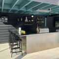 modern kitchen island with black bar stools under a blue ceiling featuring Ennis IP44 Spot Pendant Lights