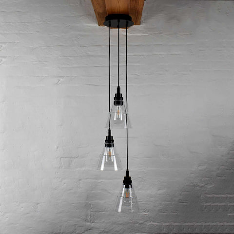 Bo Bathroom Cluster pendant light with three industrial-style clear glass shades hanging from black cords.