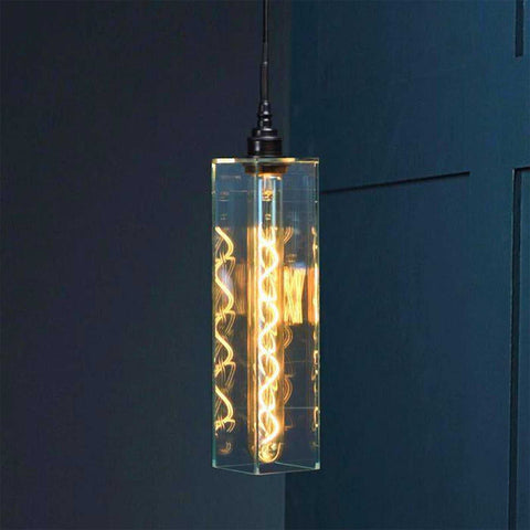 Bramley Bathroom clear glass long pendant light with decorative LED bulb hanging against dark blue wall