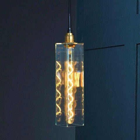 Bramley Bathroom clear long glass pendant light with decorative LED bulb against dark wall