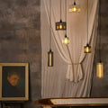 Bramley Bathroom reed glass long pendant lights with warm LED filament bulbs hanging over bathtub in vintage-style bathroom