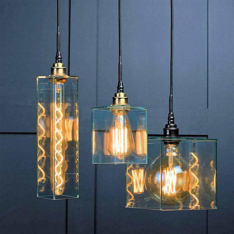 Bramley Bathroom clear globe pendant lights with minimalist cube glass shades and exposed filament bulbs hanging against a dark blue background