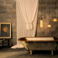 Bramley Bathroom reed glass globe pendant lights hanging above vintage bathtub in rustic bathroom