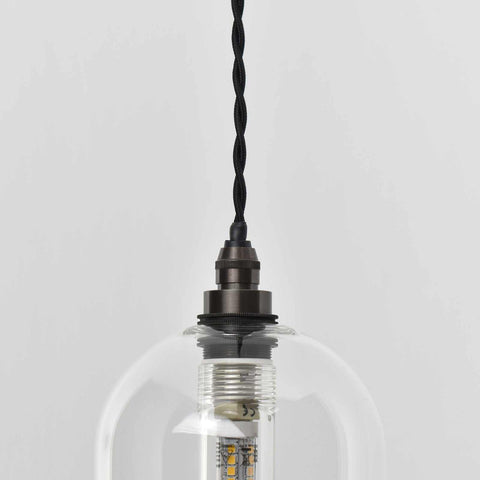 Small clear glass bathroom pendant light with adjustable cord and black metal fitting