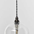Bathroom pendant light with clear glass shade and twisted black cord