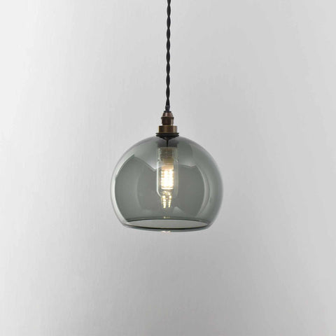 Soho Small Smoked Glass Shade bathroom pendant light with a smoked glass globe and warm glowing bulb suspended by a twisted black cord