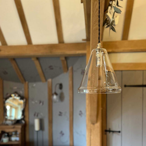 Rye Medium Clear Glass Shade handcrafted pendant light with minimalist design hanging in rustic bathroom interior