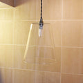 Newbury large clear glass shade pendant light hanging in modern bathroom with beige tiled wall