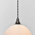 Denton Medium Ribbed ceramic bathroom pendant light with ribbed shade and warm glow