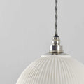 Denton Medium Ribbed ceramic bathroom pendant light with textured white shade and metal fixture hanging against gray background