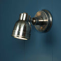 Henton Bathroom Adjustable Spotlight in antique silver with swivel joint mounted on blue wall