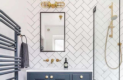Clayton Bathroom Double Well Wall Light with modern industrial design above bathroom mirror.