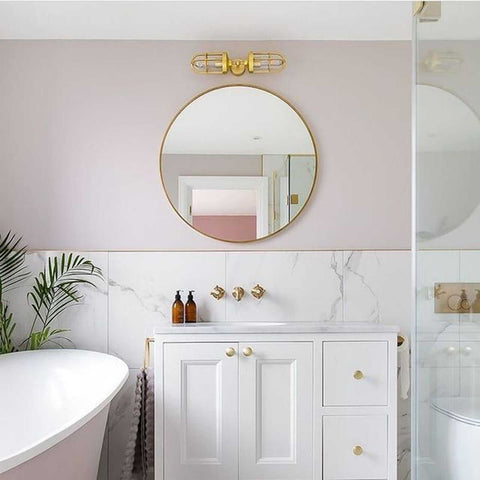 Clayton Bathroom Double Well Wall Light with modern industrial design above round mirror in stylish bathroom interior