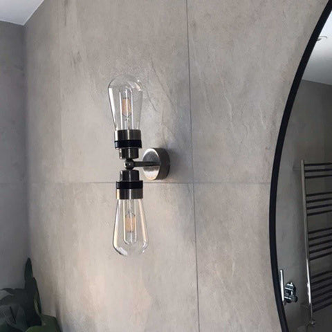 Aldbury Bathroom Double Wall Light with two clear glass shades and dimmable bulbs in satin brass finish mounted on bathroom wall