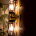 Aldbury Bathroom double wall light with satin brass finish and clear teardrop glass shades illuminating warm indoor lighting
