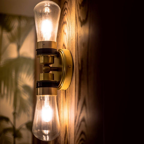 Aldbury Bathroom double wall light with satin brass finish and clear teardrop glass shades illuminating warm indoor lighting