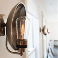 Chulainn Bathroom Dish Wall Light with brass dish shade and vintage bulb mounted on curved arm, ideal for moisture-prone spaces