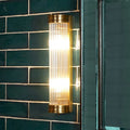Pooky Long Roddy bathroom wall light with two bulbs and glass rods, IP44 rated for wet areas, mounted on dark green tile wall