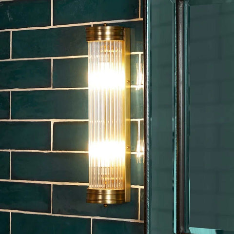 Pooky Long Roddy bathroom wall light with two bulbs and glass rods, IP44 rated for wet areas, mounted on dark green tile wall
