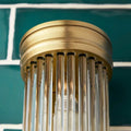 Pooky Long Roddy bathroom wall light with brass finish and vertical glass rods, stylish Art Deco design and warm lighting