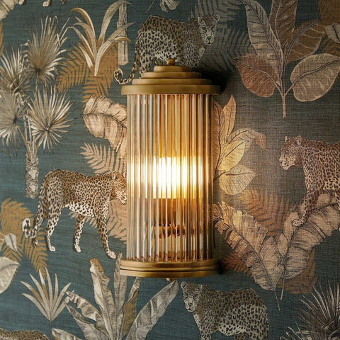 Baby Roddy Bathroom wall light with clear glass rods and polished semi-circular fitting on leopard print wallpaper