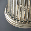 Close-up of Baby Roddy Bathroom wall light with polished metal base and clear glass rods reflecting light