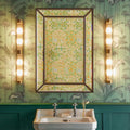 Pooky Rodtastic Bathroom Wall Light in brass finish flanking a vanity mirror in a stylish bathroom setting