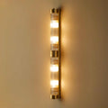 Pooky Rodtastic Bathroom Wall Light in brass finish with multiple illuminated bulbs and sleek modern design
