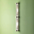 Pooky Rodtastic Bathroom Wall Light in nickel finish mounted on green wall, sleek modern double-length design ideal for bathroom vanity lighting