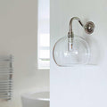 Soho Medium Clear Glass Shade bathroom wall light with curved swan neck and clear glass globe mounted on white wall
