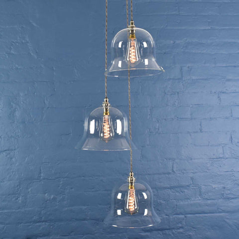 Bodium large clear glass shade cluster pendant light with hand-blown glass and adjustable cords against blue brick wall