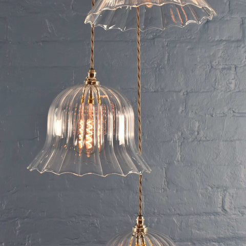 Bodium Large Ribbed Cluster Pendant Light with handcrafted ribbed glass shades and vintage-style filament bulbs against a textured gray wall