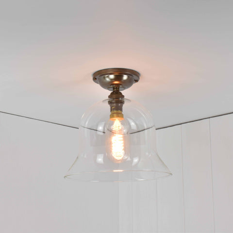 Bodium medium clear glass shade flush ceiling light with hand-blown bell-shaped design and brass fixture.