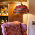 Large woven colourful basket pendant light made from natural elephant grass hanging from ceiling