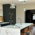 Modern kitchen with marble island and bar stools