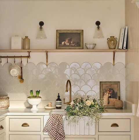 small rye ribbed lightKitchen with white cabinets, a decorative backsplash, and a sink area.