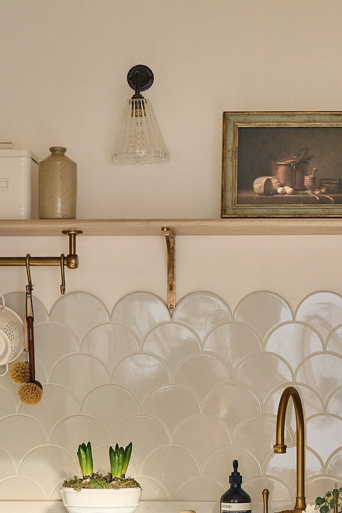 Kitchen with white cabinets, a sink, and decorative elements.