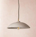 Corleone Concrete Pendant Light solid concrete curved hemisphere with grey finish hanging over dining table