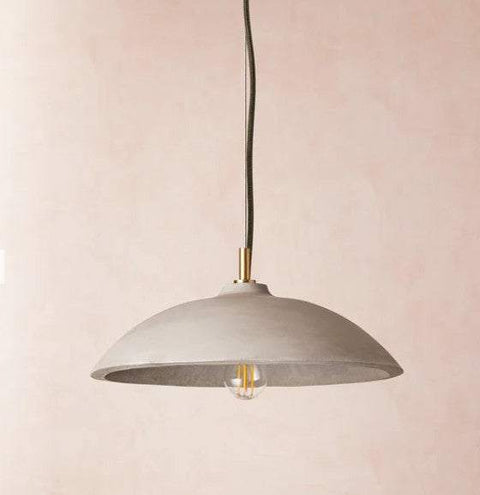 Corleone Concrete Pendant Light solid concrete curved hemisphere with grey finish hanging over dining table