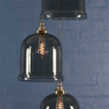 Hythe medium smoked glass shade cluster pendant light with hand-blown bell-shaped shades and warm ambient lighting